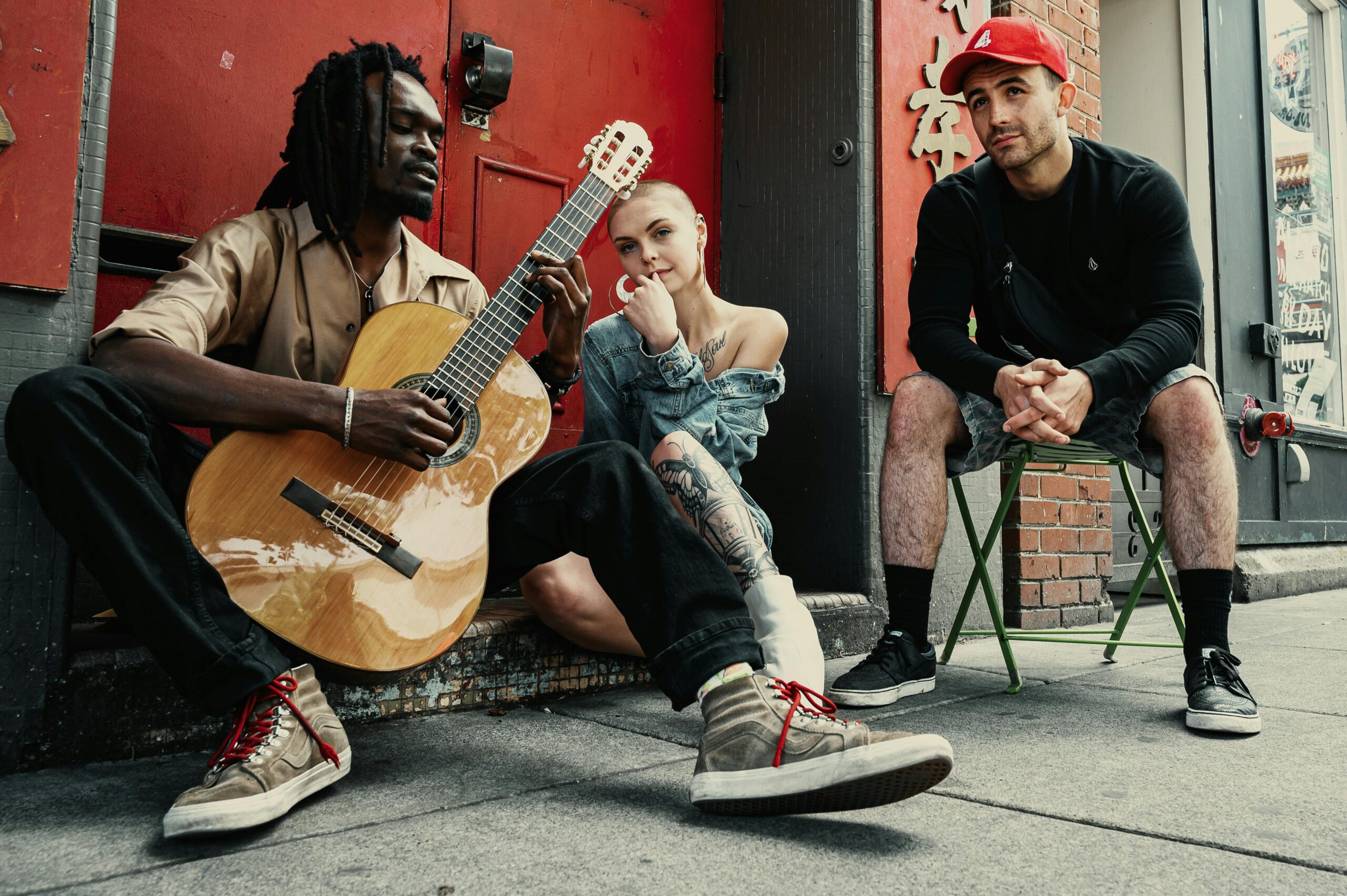 Diverse musicians perform on a city street, showcasing urban culture and friendship.